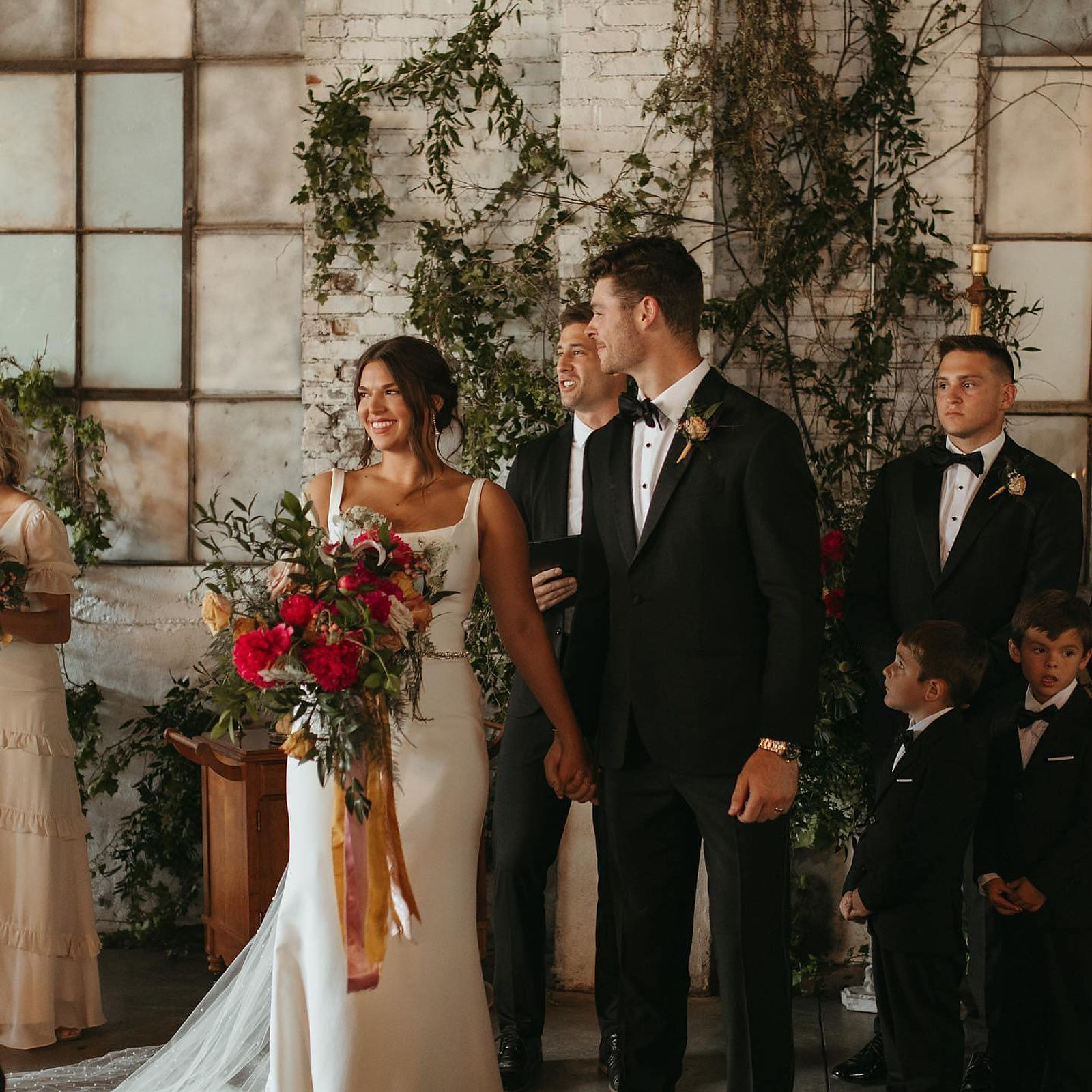 A close portrait of a couple beneath the ceremony arch inside the ballroom.