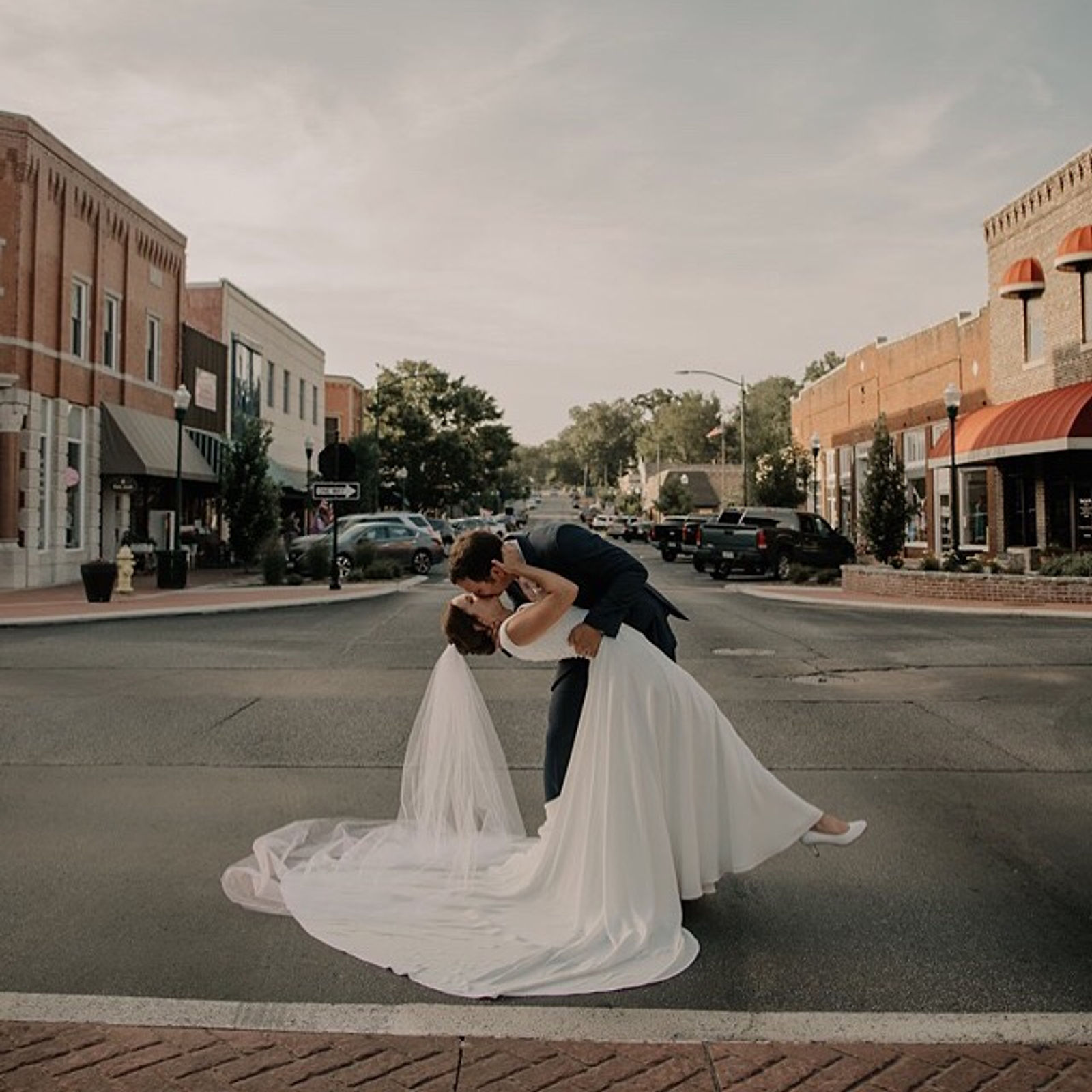 A couple sharing a dip-kiss in the middle of Main Street in downtown Siloam Springs.