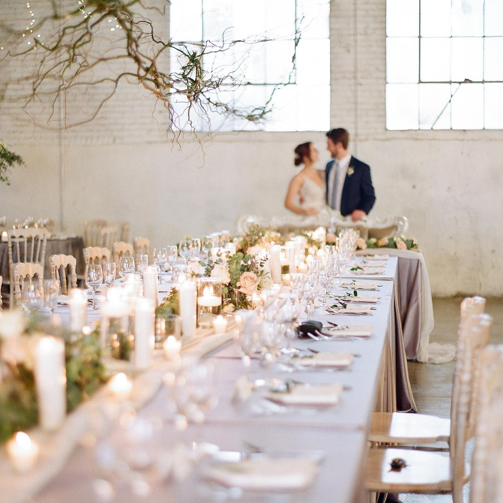 An intimate candlelit table setting in the venue's lobby space.